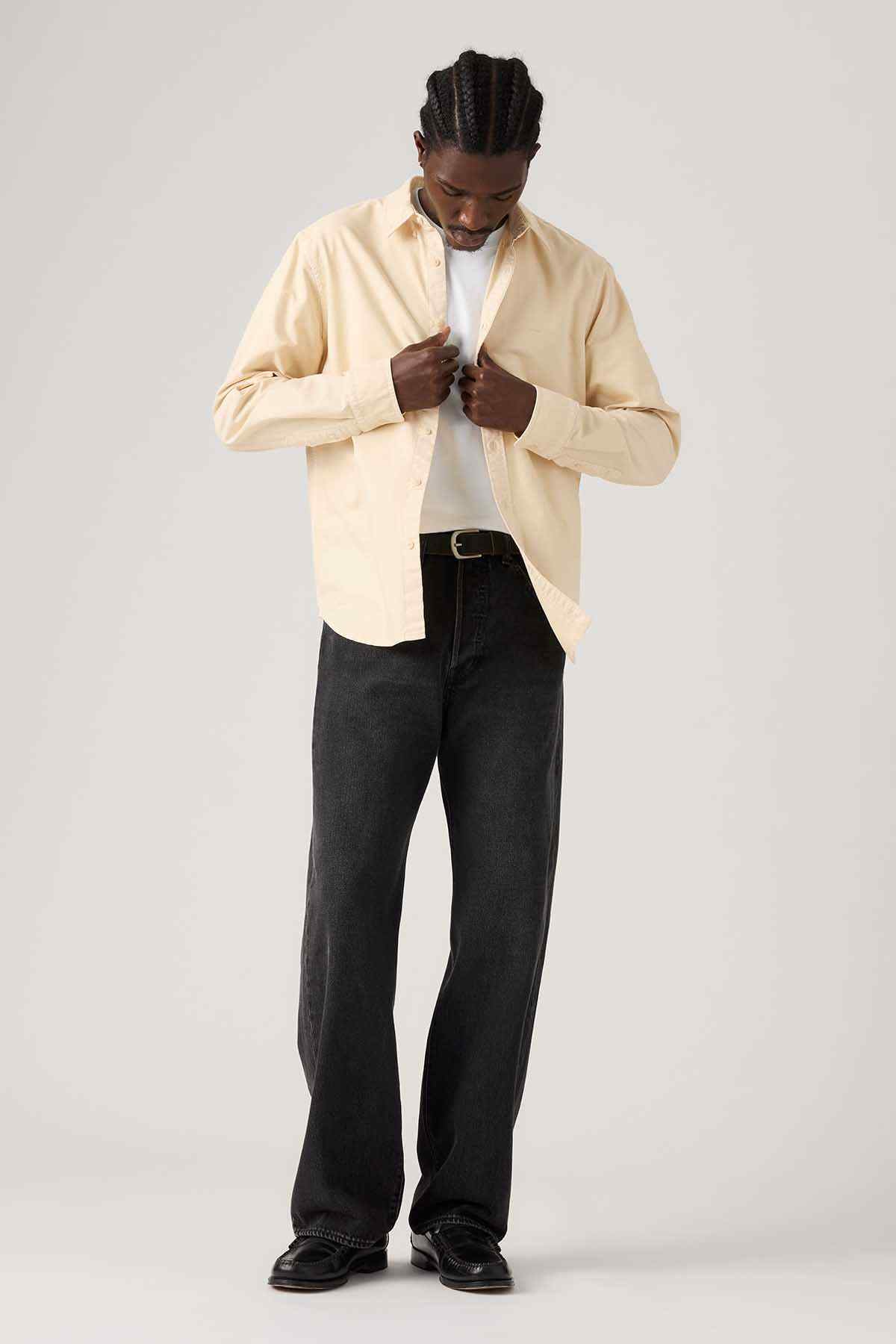 Black denim jeans with button fly, belt loops, and dark wash finish