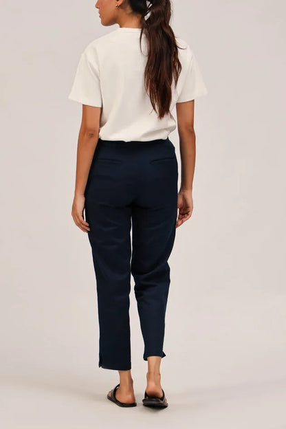 Navy blue tailored trousers with flat front and cuffed hem