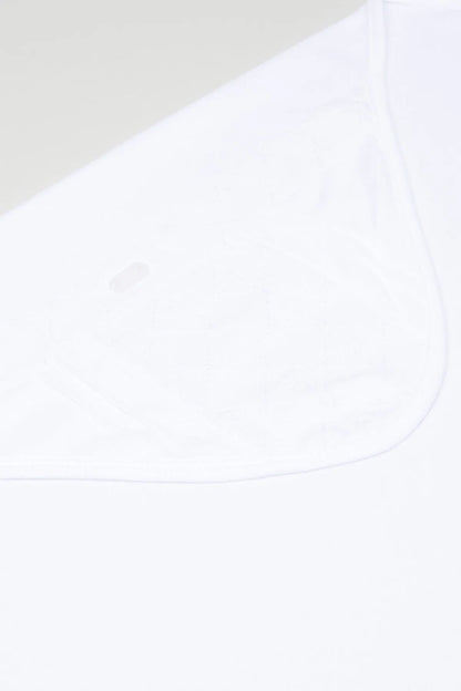 White baby blanket fabric close-up with curved stitched edge