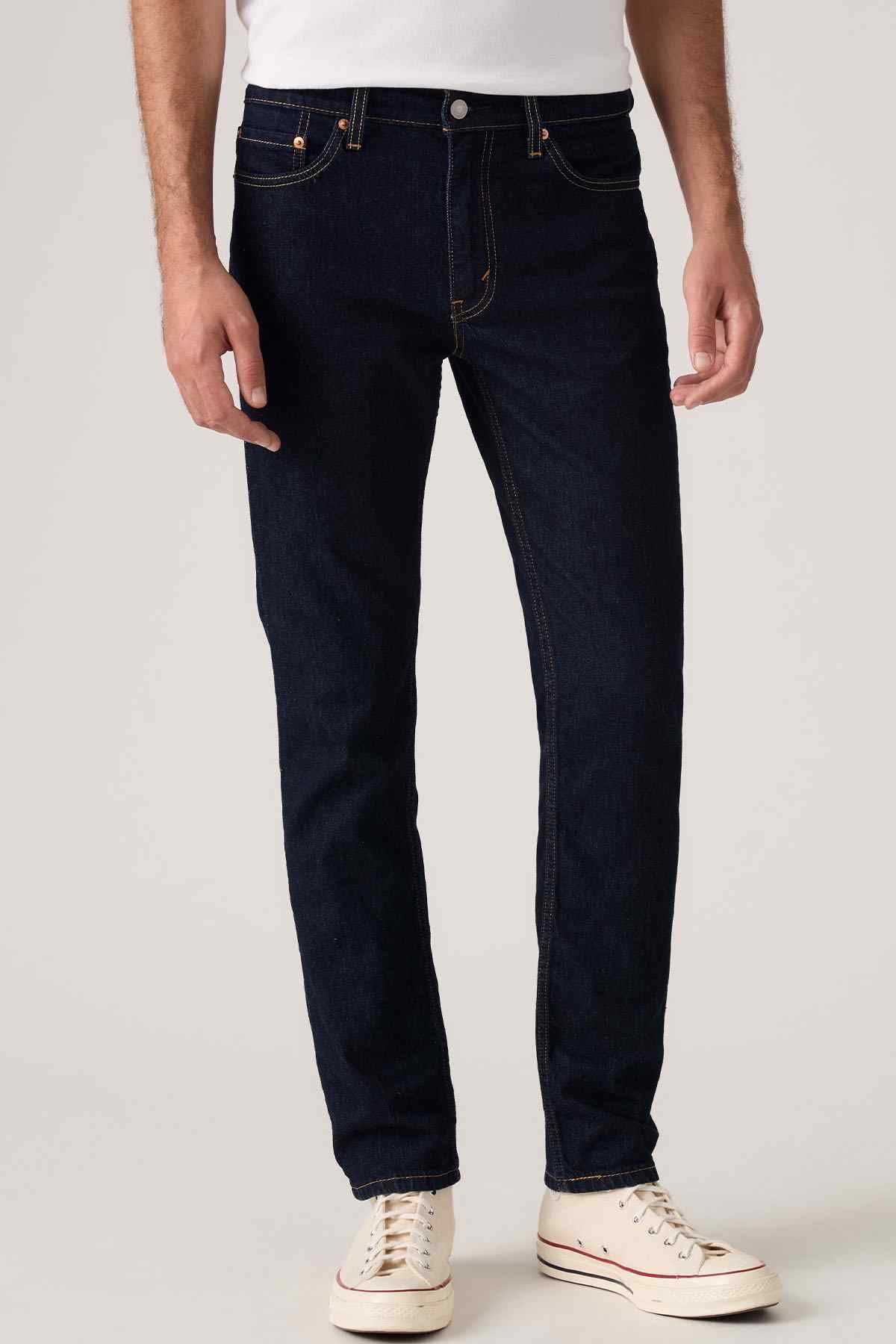 Dark blue denim jeans with button fly, belt loops, and five-pocket styling