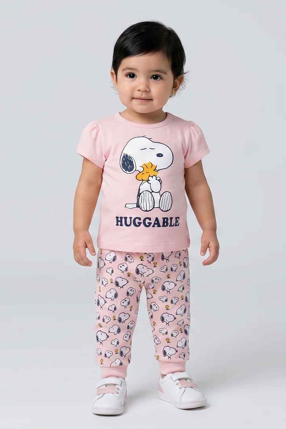 Pink baby pajama set with Snoopy-style graphic T-shirt and printed pants