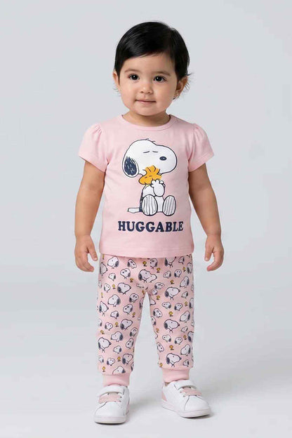 Pink baby pajama set with Snoopy-style graphic T-shirt and printed pants