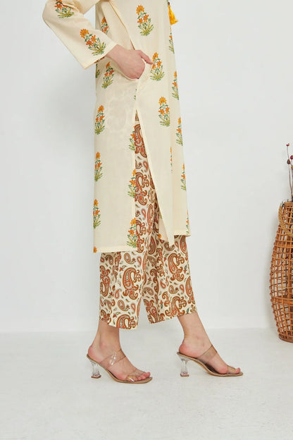 Cream printed kurta over orange paisley-pattern palazzo pants with open-toe sandals