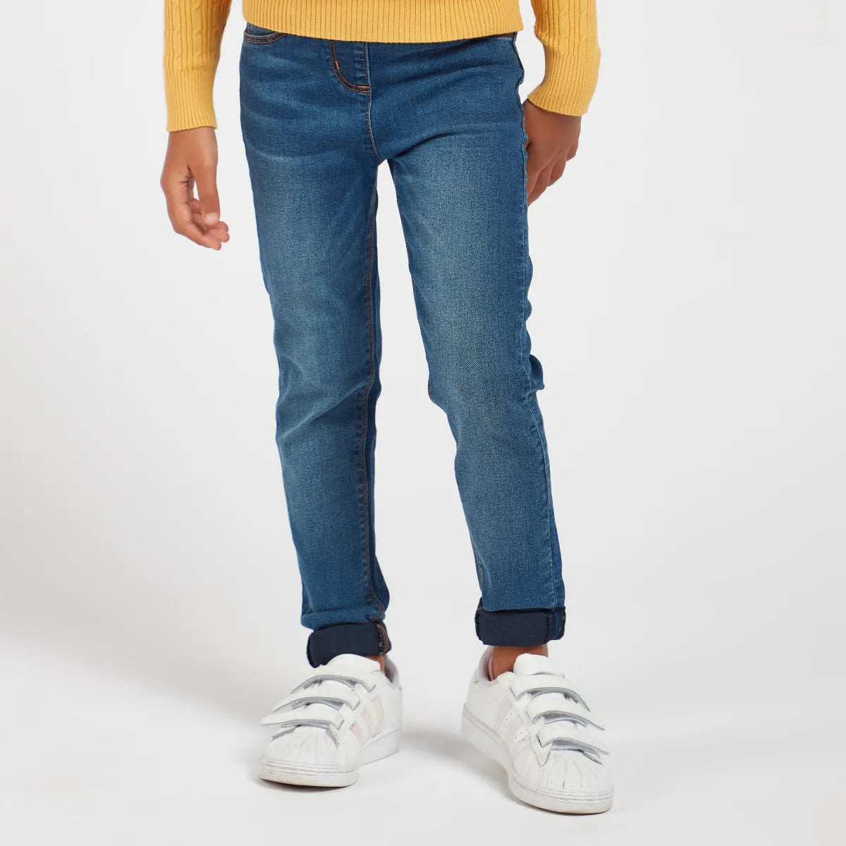 Cuffed blue denim jeans with stitched seams and belt loops