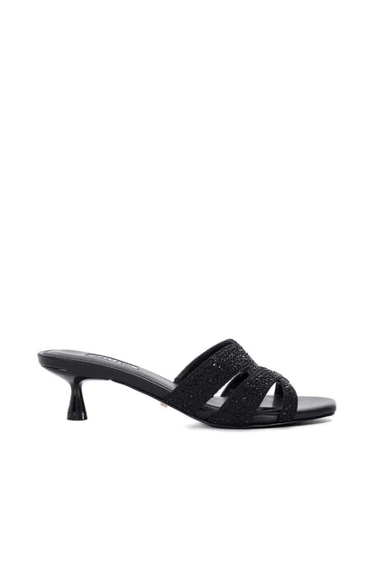 Black heeled mule sandal with glitter strap across the foot and curved sole