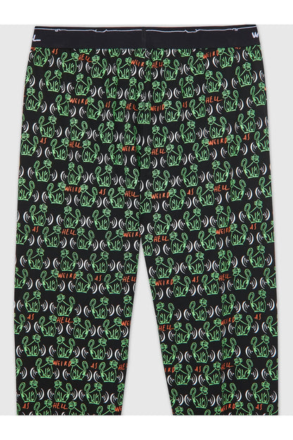 Black pants with all-over green graphic repeat pattern, tapered jogger leg