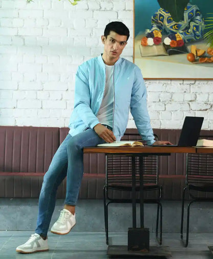 Light blue bomber jacket with zipped front and stand collar
