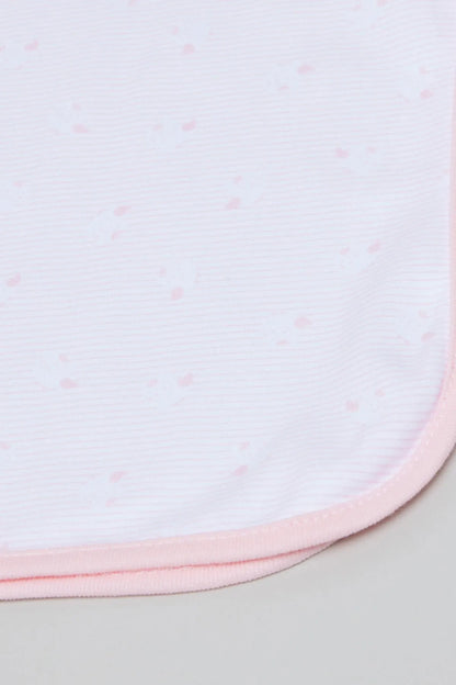Light pink baby blanket close-up with tiny dots and stitched hem edge