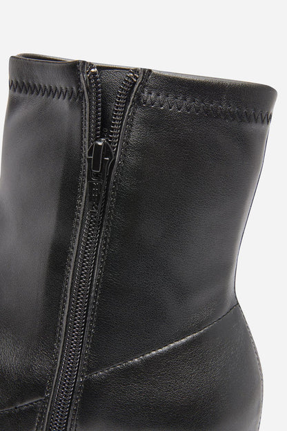 Black leather ankle boot upper with silver side zipper close-up
