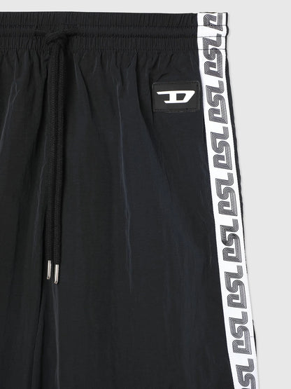Black track pants close-up: elastic waist, drawstring, white logo side stripe