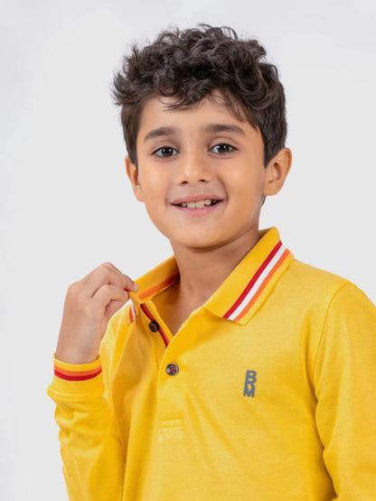 Yellow kids polo shirt close-up with striped collar and chest logo