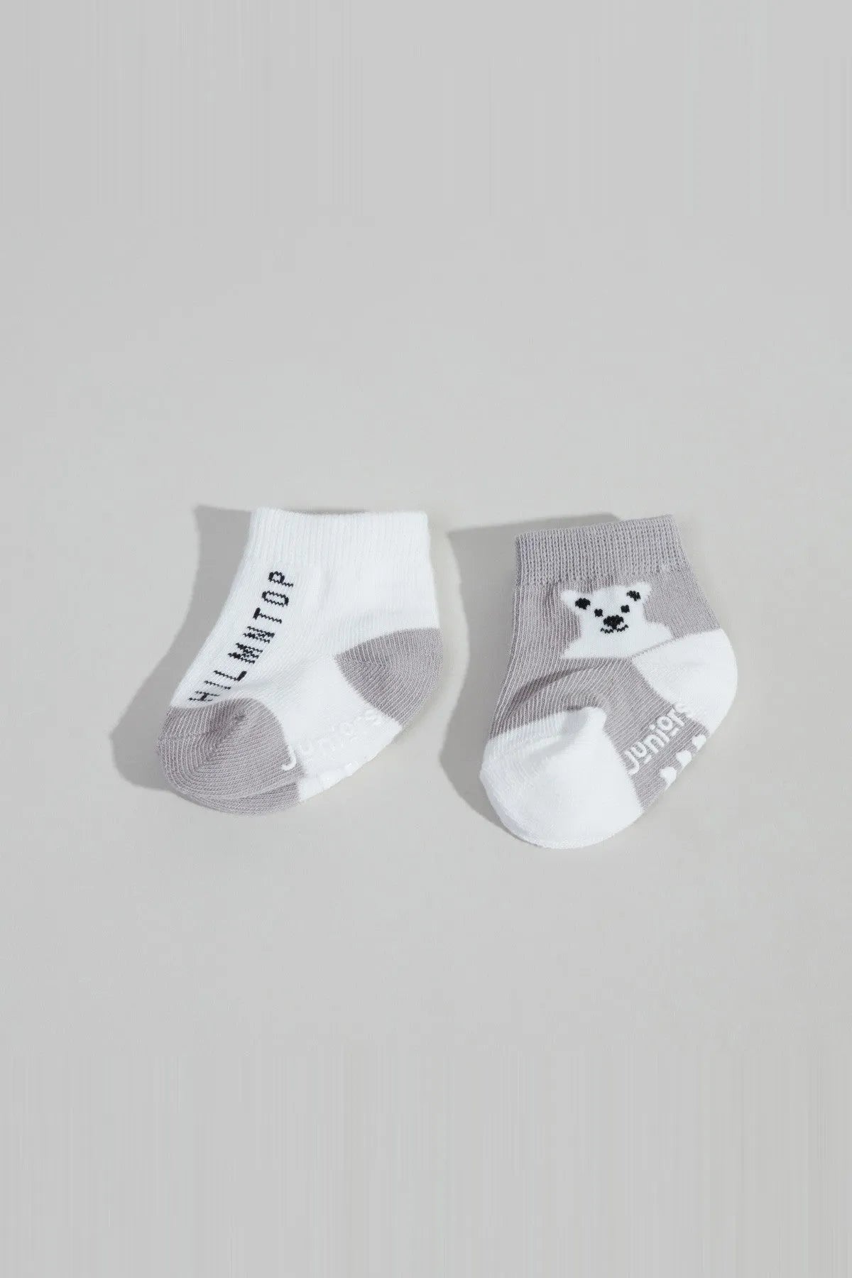 Baby socks in white and grey with bear face graphic and ribbed cuff