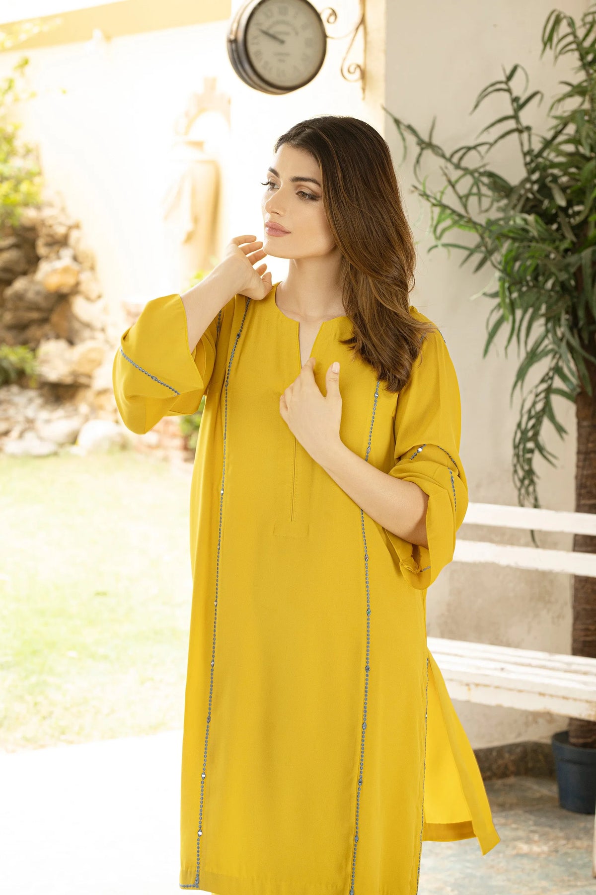 Lime yellow velour tunic close-up with round neckline and long sleeves