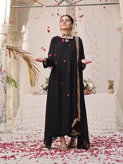 Black long dress with gold-edged border and small red petal prints, full length