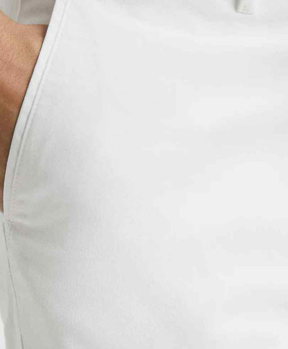 White chino fabric close-up with stitched seam and smooth texture