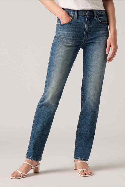 Dark indigo straight-leg jeans close-up of belt loops and button fly