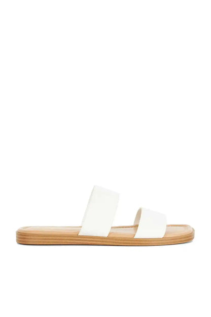 Dune London white slide sandals, side view with two wide straps and tan footbed