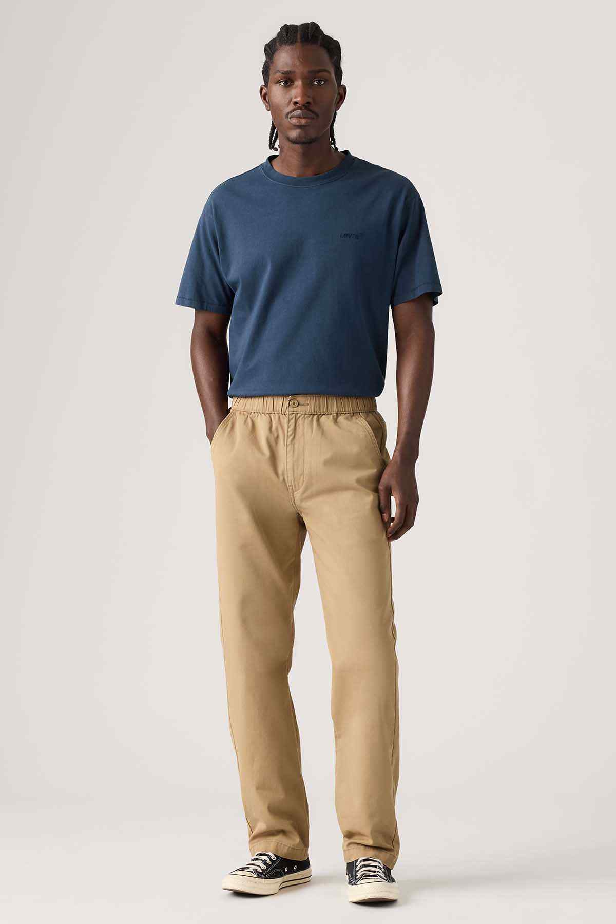 Tan casual jogger pants with elastic waistband, side pockets, and drawstring