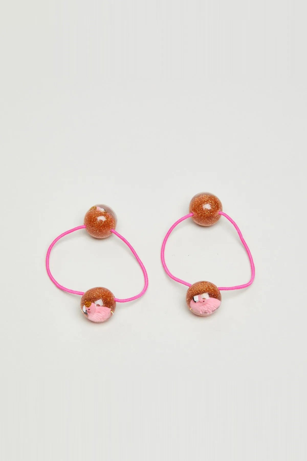 Pair of pink hair ties with glitter brown beads and small pink pig face charms