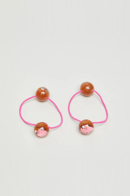 Pair of pink hair ties with glitter brown beads and small pink pig face charms