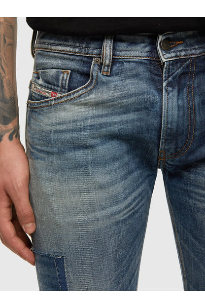 Blue denim jeans close-up of front pockets, stitching, and button fly
