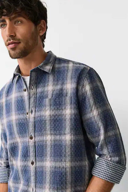 Men’s blue plaid button-up shirt with collar and button placket