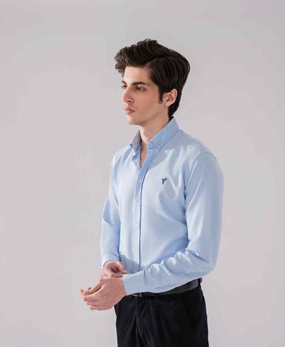 Light blue fitted button-up shirt with spread collar and long sleeves, chest logo.