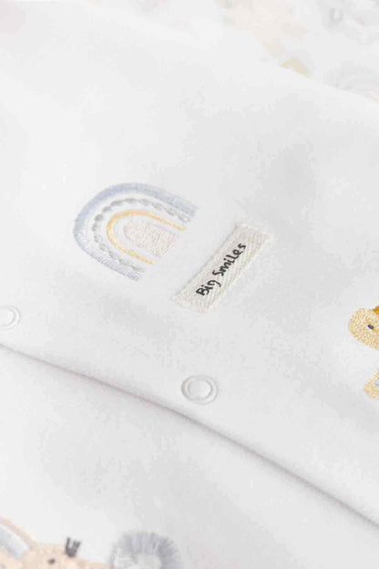 White baby bodysuit with blue-and-yellow rainbow applique and stitched side label
