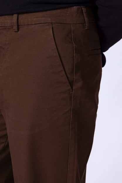 Men's brown chinos, close-up of front pocket and stitched waistband