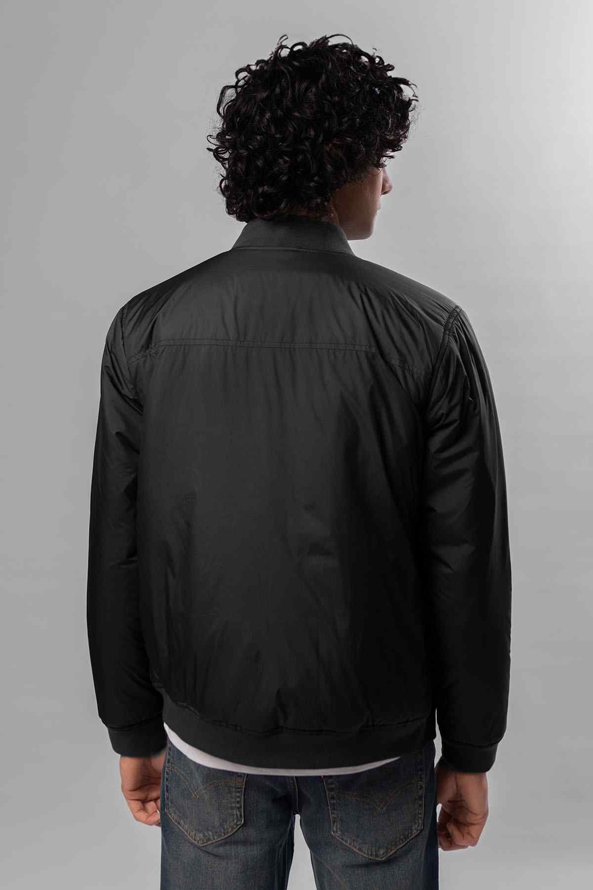 Black bomber jacket back view with zip front and ribbed hem and cuffs