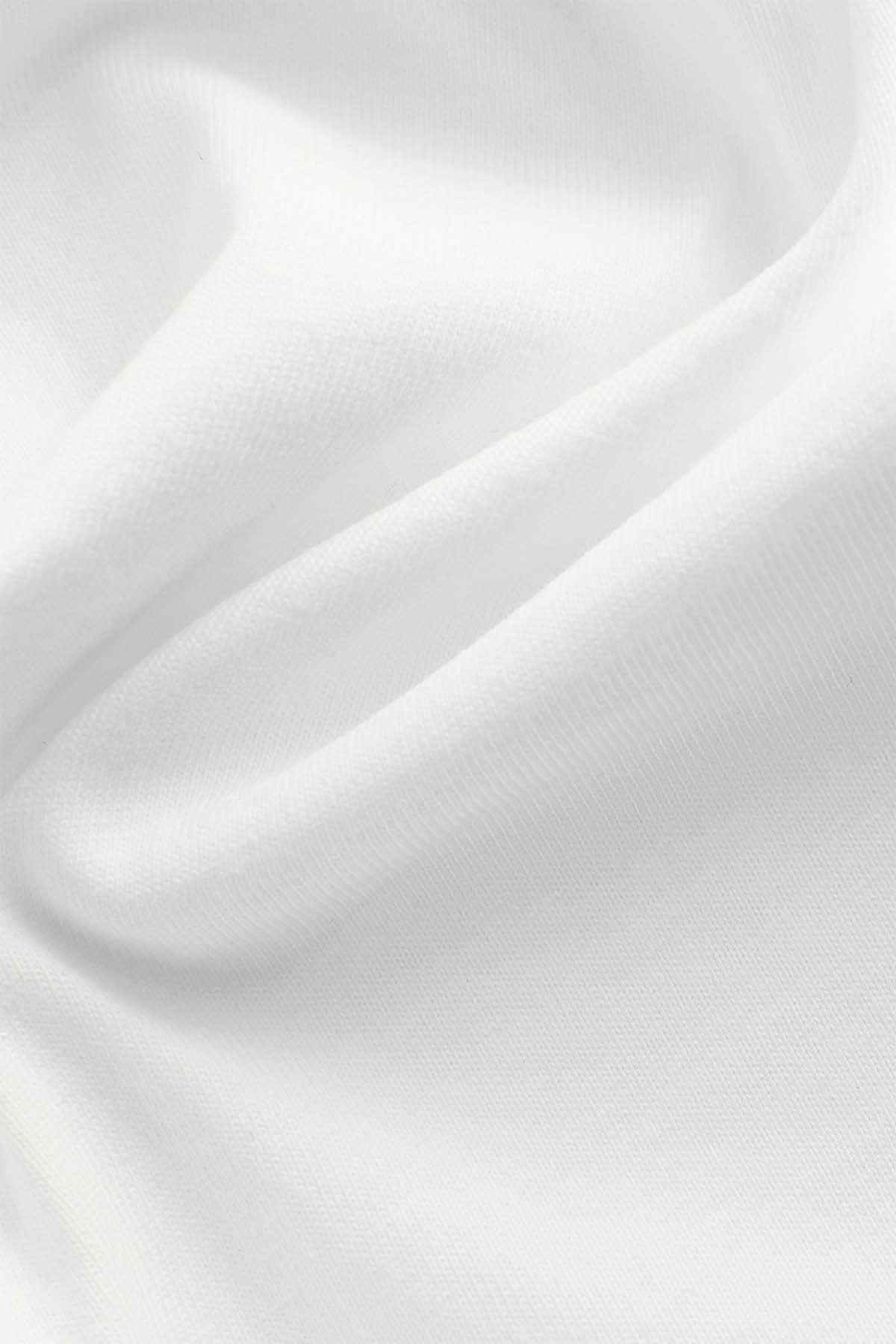 White knit fabric close-up with fine texture