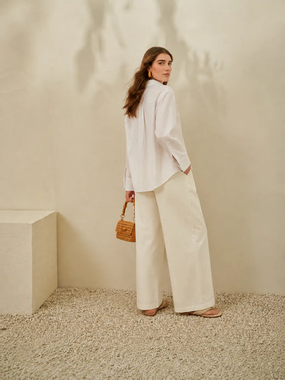White button-up shirt and wide-leg trousers, side profile, long sleeves