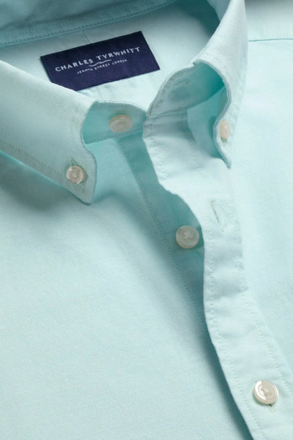 Light aqua green button-up shirt with gold-tone buttons and neck label