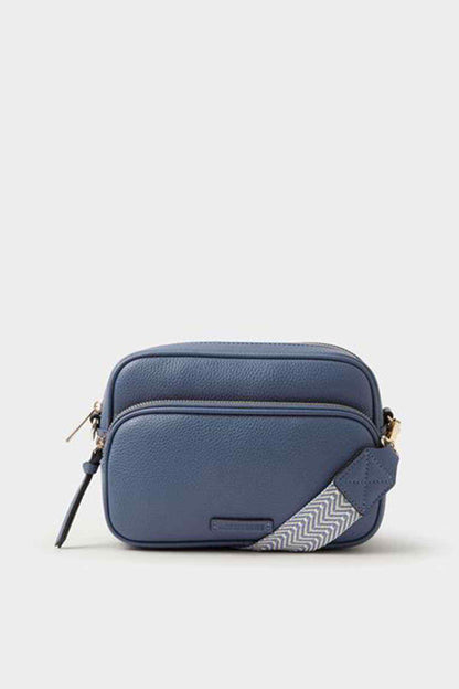 Blue mini crossbody bag with front pocket, rounded shape, gold zipper pulls