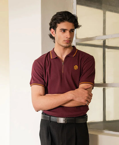 Maroon fitted polo shirt with zip placket, yellow trim, and small chest crest