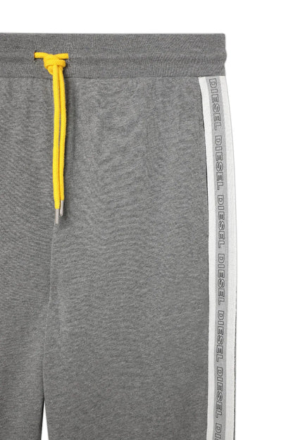 Gray jogger pants with yellow drawstring and vertical white logo stripe
