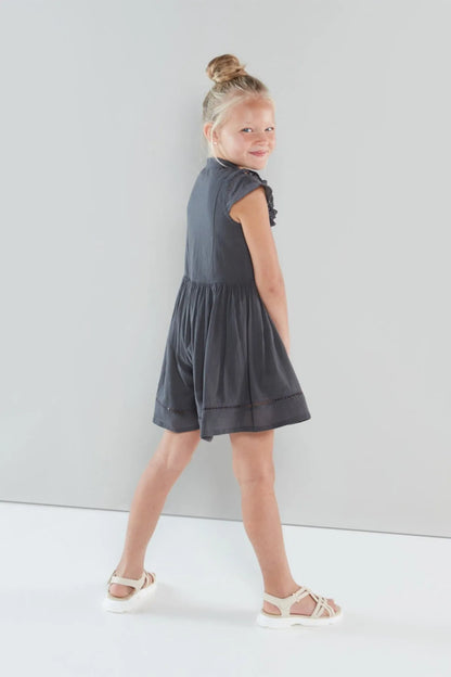 Girls' dark grey sleeveless tiered dress with gathered waist and button front