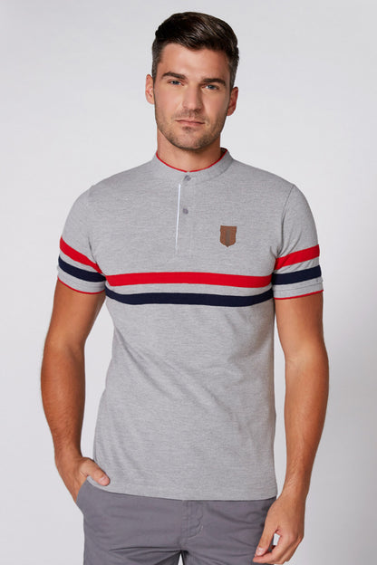 Grey polo shirt with button placket and red, white, navy striped band across chest