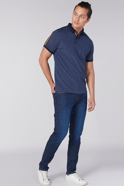 Navy short-sleeve polo shirt with orange-trim collar and placket, worn with jeans