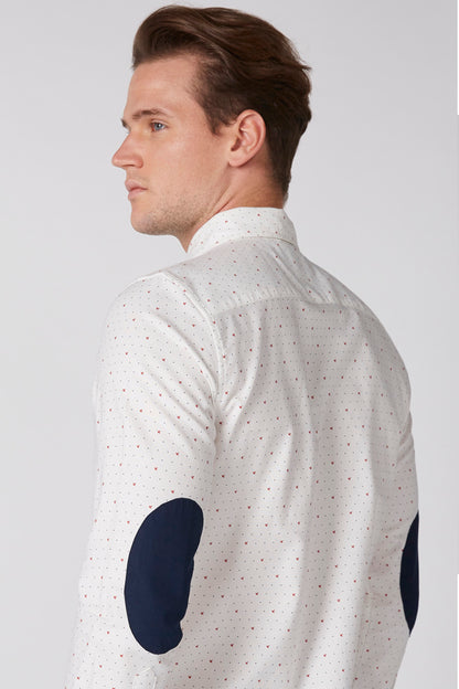 White button-up shirt with small dotted print and navy oval sleeve accents