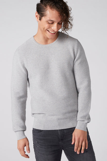 Heather grey crewneck sweater with long sleeves and ribbed cuffs
