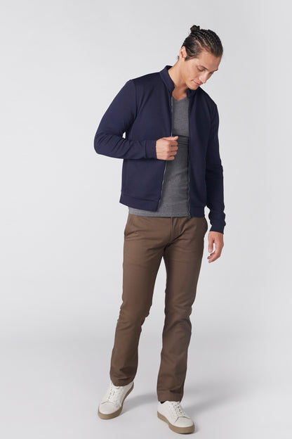 Men's navy zip-up jacket worn over a gray shirt, long sleeves