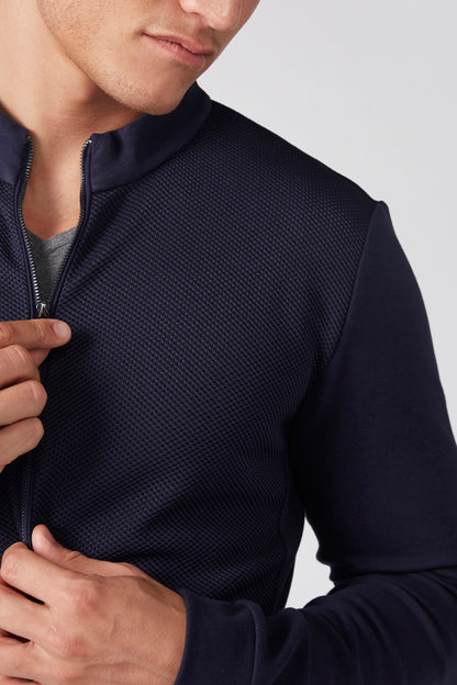 Navy textured zip-up jacket close-up with front zipper and stand collar