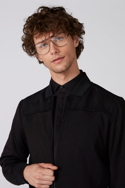Men's black zip-up jacket close-up with stand collar and chest flap pockets