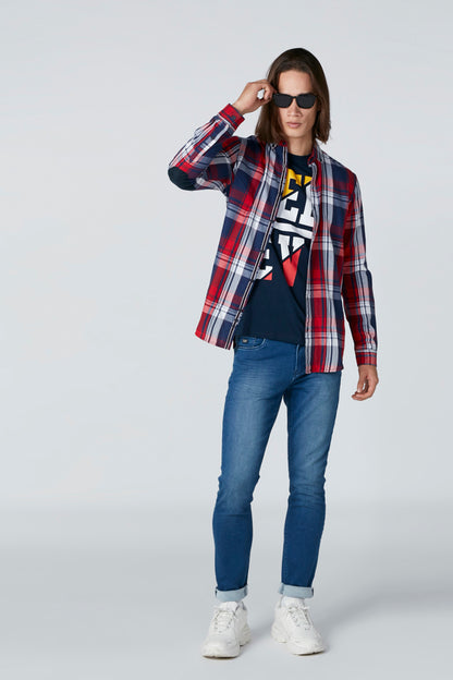 Red, blue, and white plaid zip-front jacket with graphic top underneath