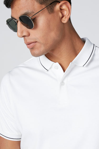 White polo shirt close-up with ribbed collar and three-button placket