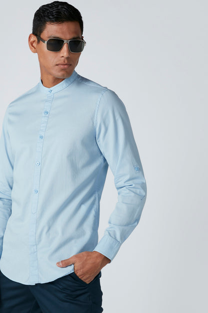 Light blue button-up dress shirt, angled side view, long sleeves and front buttons