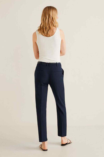 Dark navy trousers with white sleeveless top, back view
