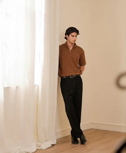 Fitted half-zip short-sleeve shirt in brown worn with black trousers