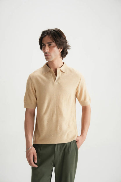 Beige knit polo shirt with open collar and short sleeves, button placket.
